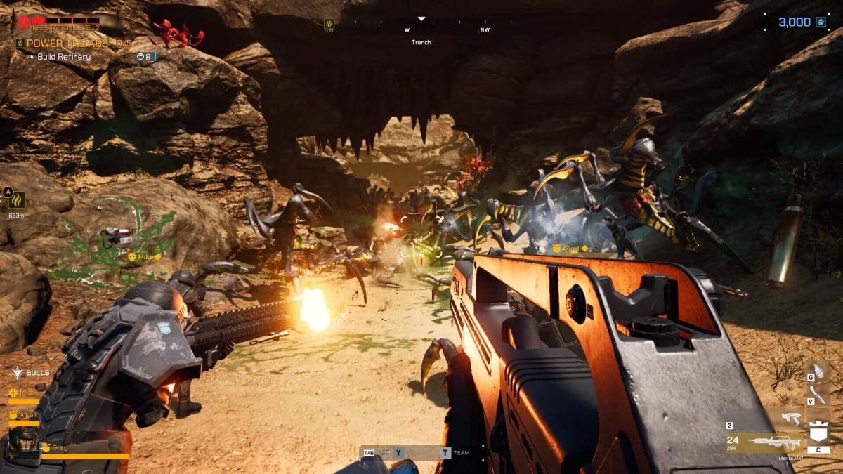 A couple of players are fighting a bunch of bugs in a desert environment. 