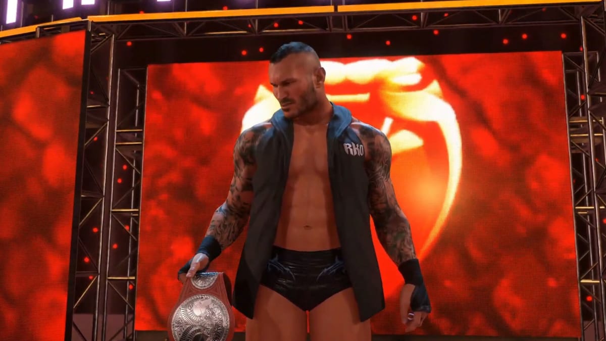 A mid-shot of Randy Orton holding a championship belt in WWE 2K22, courtesy of Wrestling Game Archive