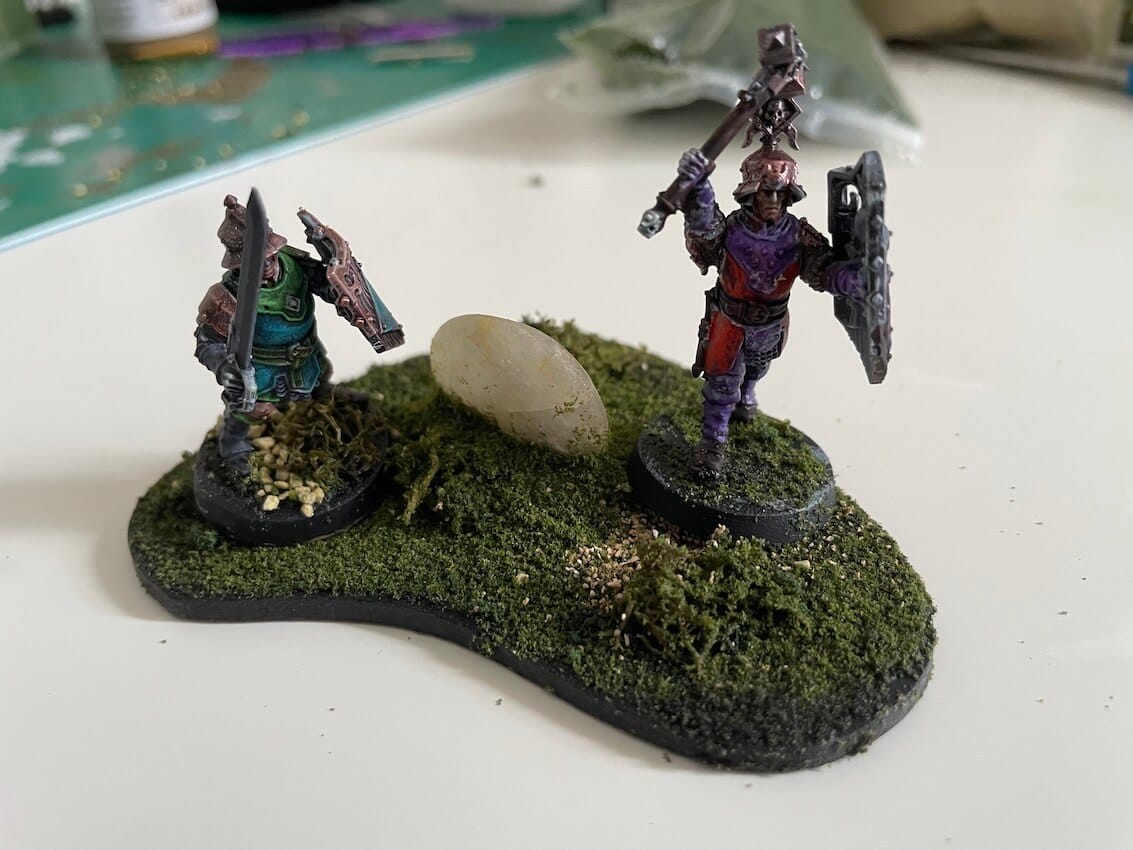 Two soldiers guard a strange stone in a piece of scenery using All Game Terrain products