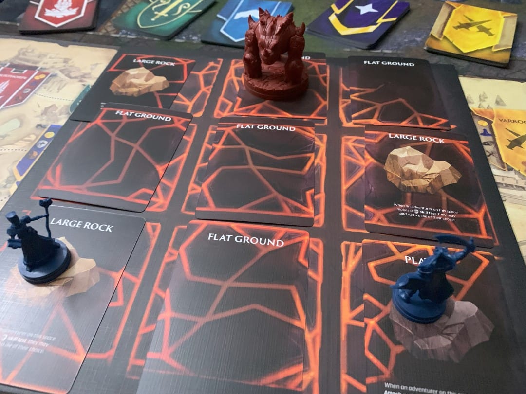 A screenshot from Runescape Kingdoms Shadow of Elvarg, showing a grid with lava cards, two adventurers, and a miniature of a lava monster