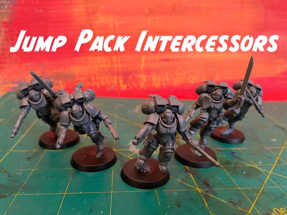 Warhammer 40K Fall 2023 Space Marines - Jump Pack Intercessors miniatures against a red background
