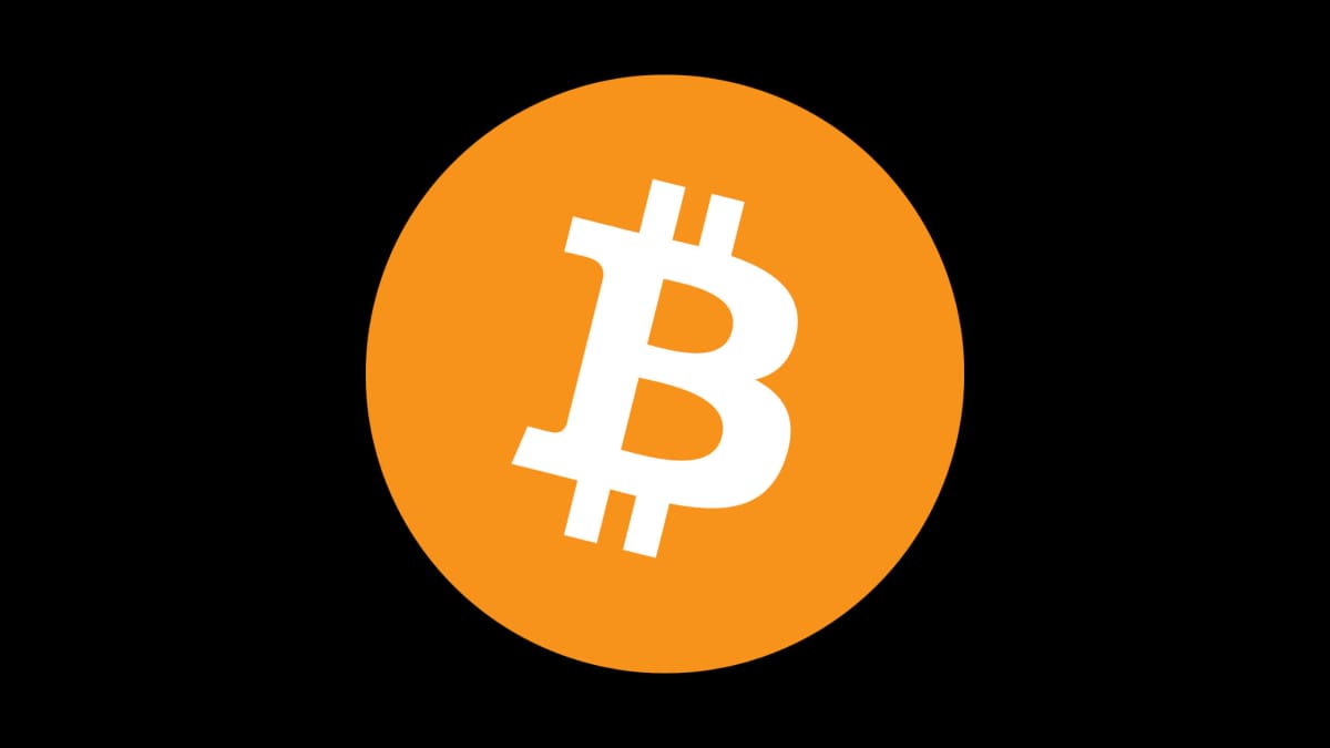 The Bitcoin logo against a black backdrop