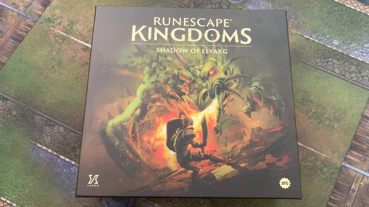 A screenshot of a box of Runescape Kingdoms Shadow of Elvarg on a gaming mat.