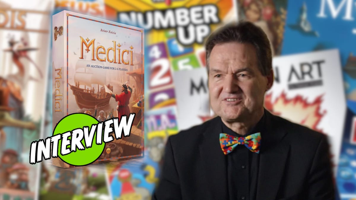 Reiner Knizia and the Medici box against a background of his other games