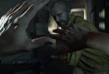 Jack Baker attacking Ethan, who is defending himself with his hands, in Resident Evil 7