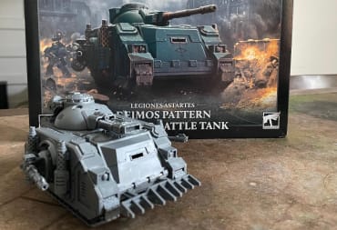 The Horus Heresy Plastic Predator Battle Tank displayed in front of it's box packaging.