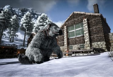 A creature in Ark: Survival Evolved sitting outside a snow-capped house