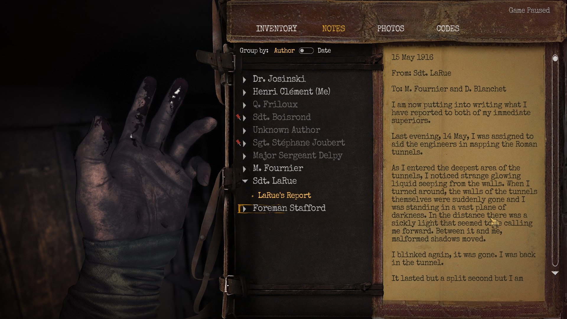 Amnesia: The Bunker screenshot showing a blood-covered hand and a journal filled with notes. 