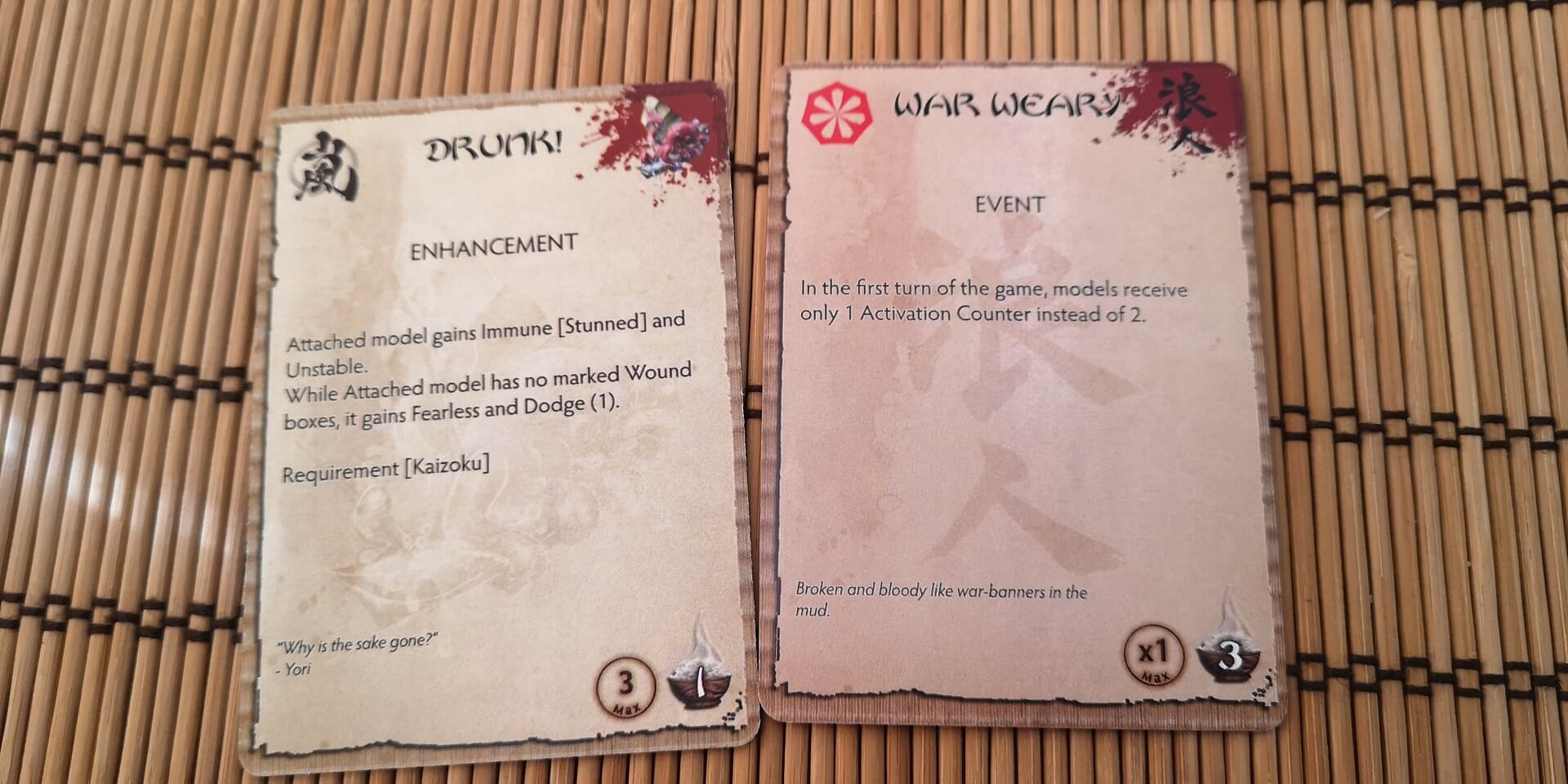 A side by side image to compare the quality of a card from the Bushido Year of the Risen Sun and Weeping Sky decks.