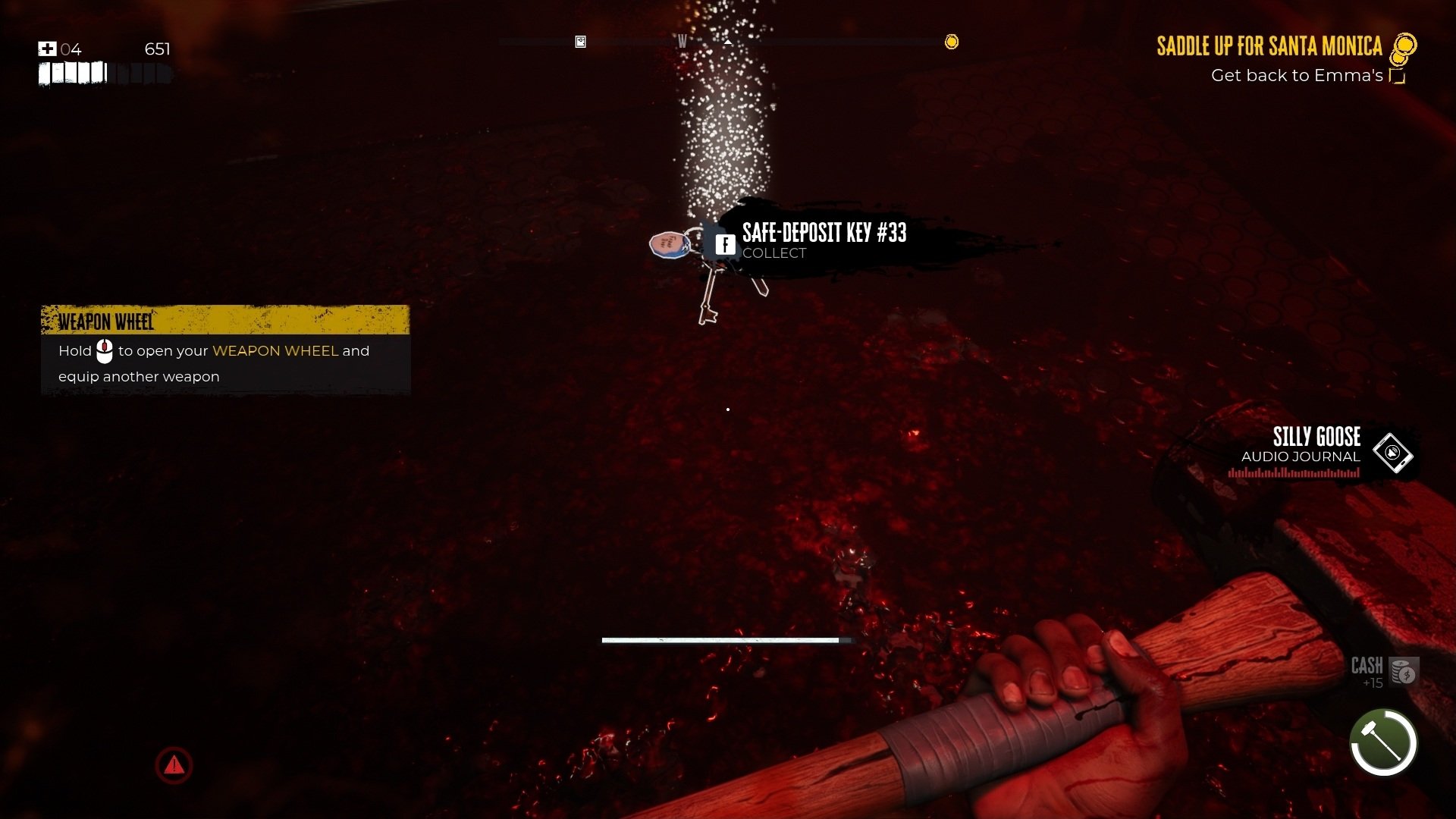 Dead Island 2 screenshot showing a key lying in an insane pool of gore and viscera. 