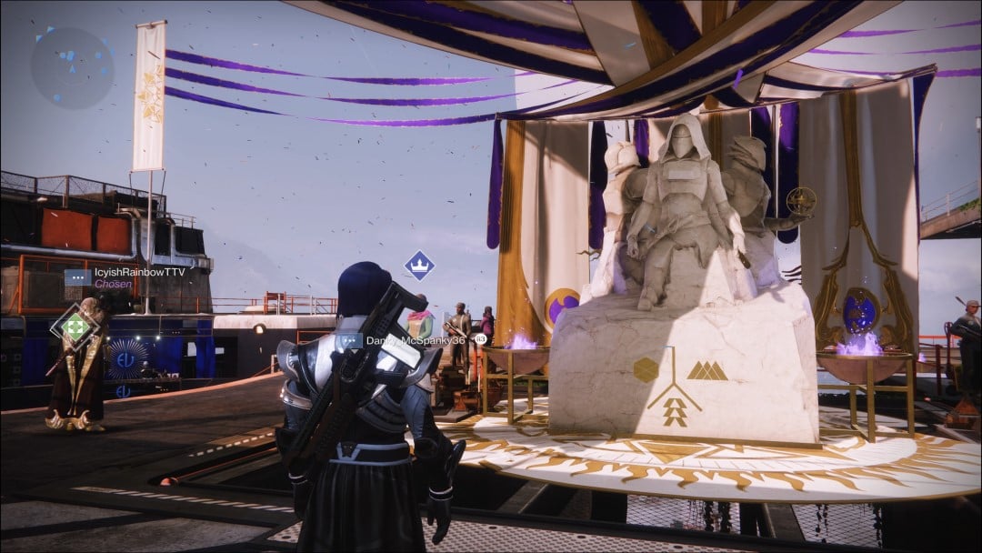 A warlock looking a marble statue of three heroes