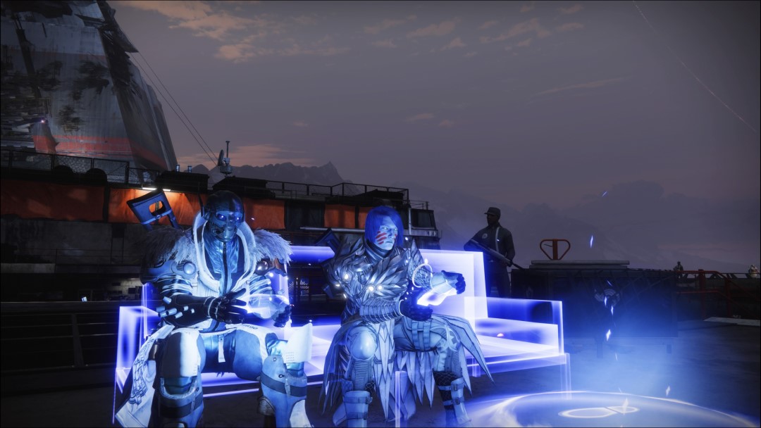 A Warlock and Titan sitting on a couch, controllers in hand.