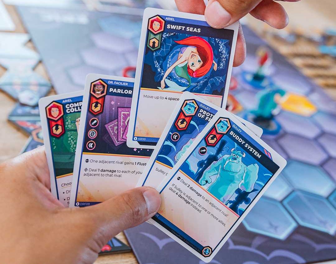 A hand of cards showing artwork from the Disney Sorceror's Arena Board Game