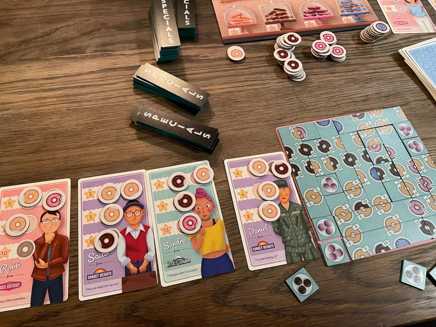 A full and complete player board in Dollars To Donuts, which ends the game