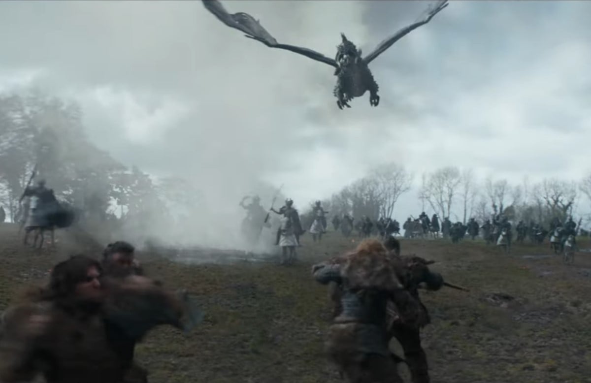 A black dragon swooping down on to a battlefield