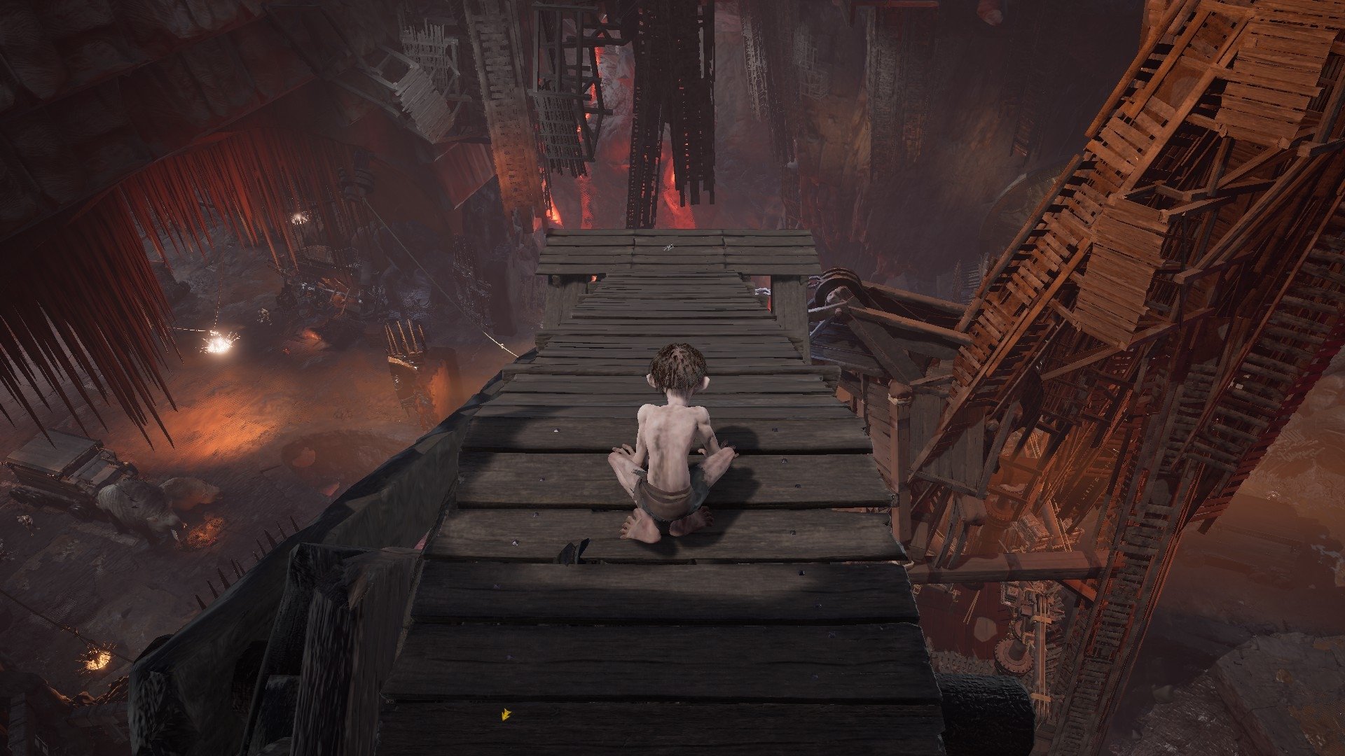 Gollum screenshot showing Gollum standing on an arm that is reaching out over a chasm. 