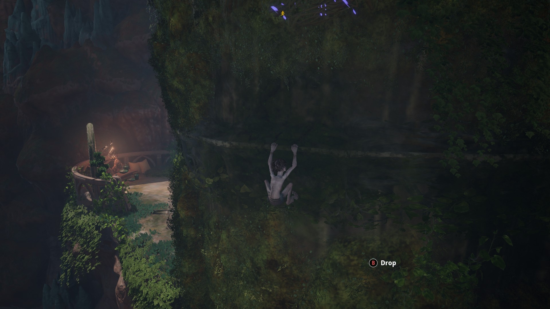 Gollum screenshot showing gollum shimmying along a ledge mostly covered in vines. 