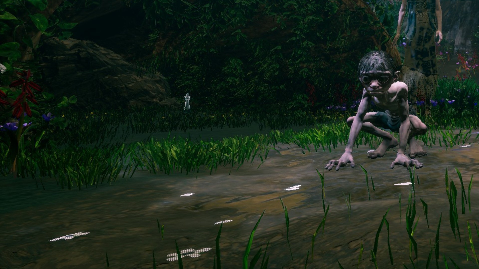 Gollum screenshot showing a log with a glowing figurine inside it, while Gollum stands in the foreground. 