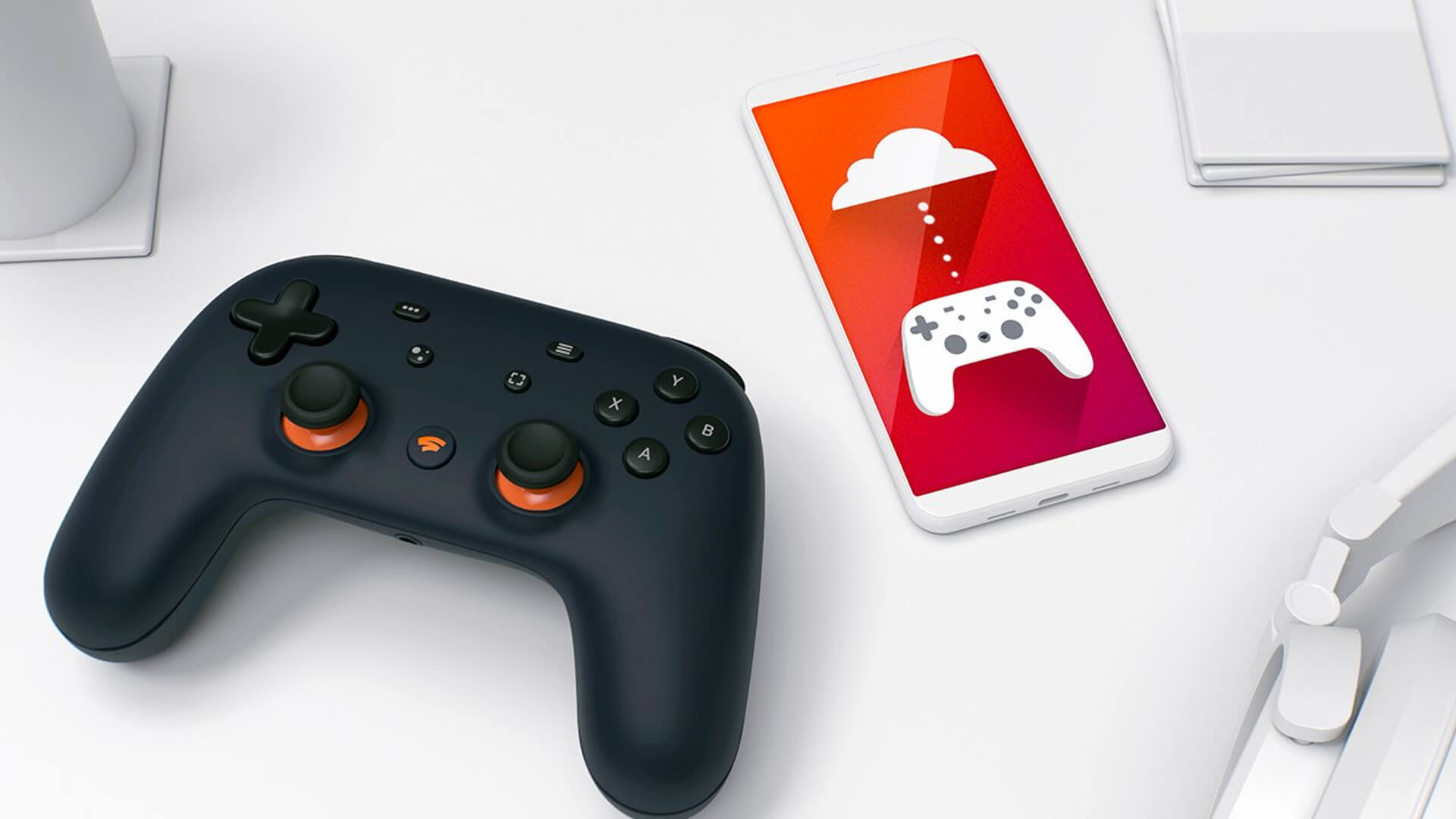 A Google Stadia controller and a phone showing a Google Stadia icon