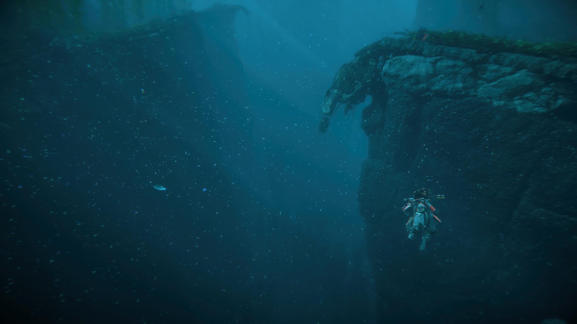 Aloy swimming through a deep underwater canyon in Horizon Forbidden West