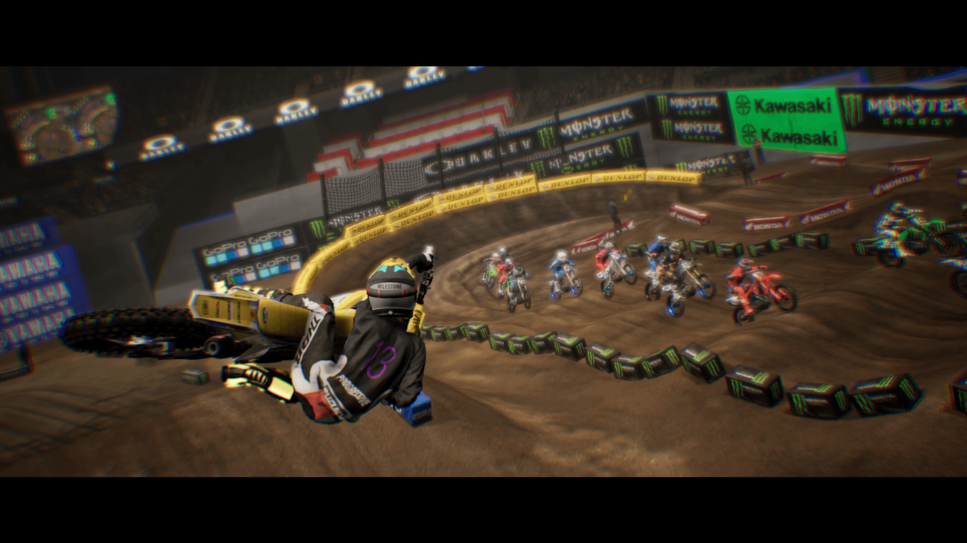 An in-game screenshot of Monster Energy Supercross 6, showcasing a racer executing a scrub, while other riders are catching up to them in the background.