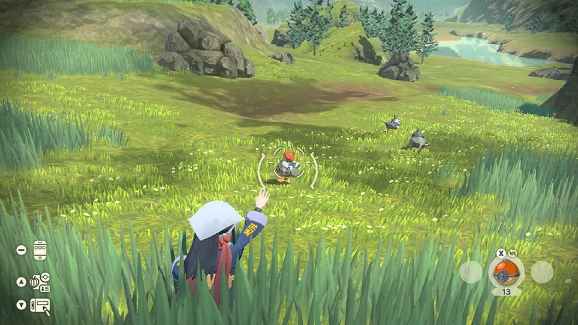 The player throwing a Poke Ball at Starly in Pokemon Legends Arceus