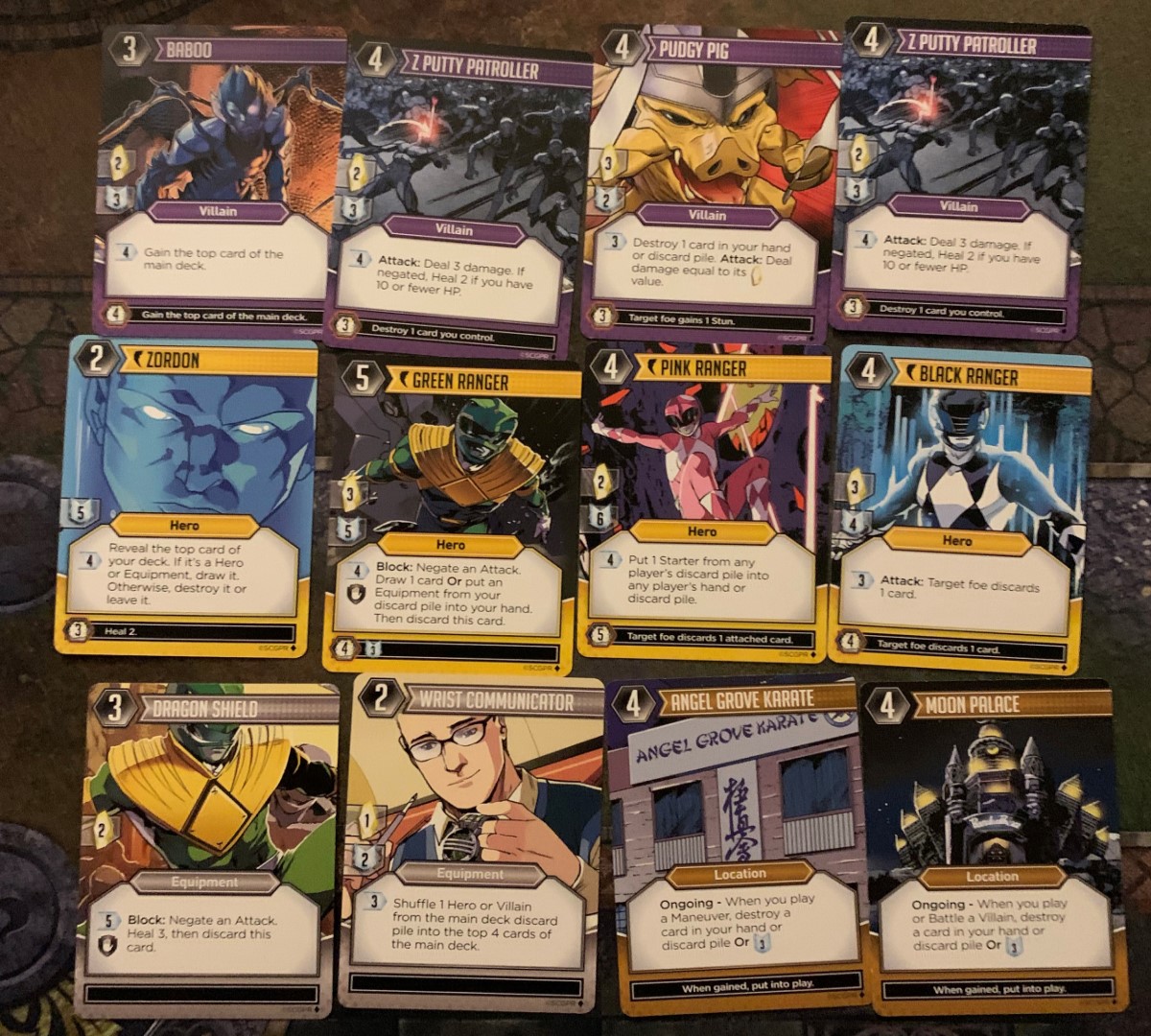 A spread of different hero and villain cards for Power Rangers The Deck Building Game