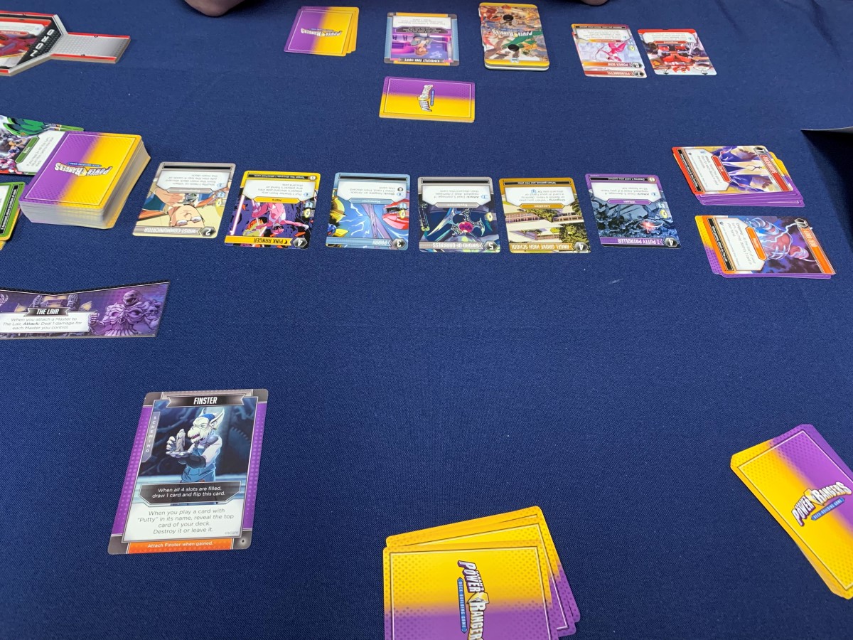 A Power Rangers The Deck Building Game match between Finster and Kimberly.