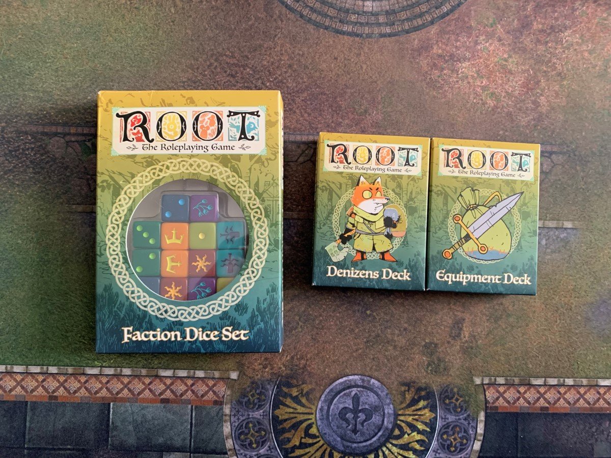 A pack of dice and two decks of cards showing denizens and weapons for Root: The RPG.