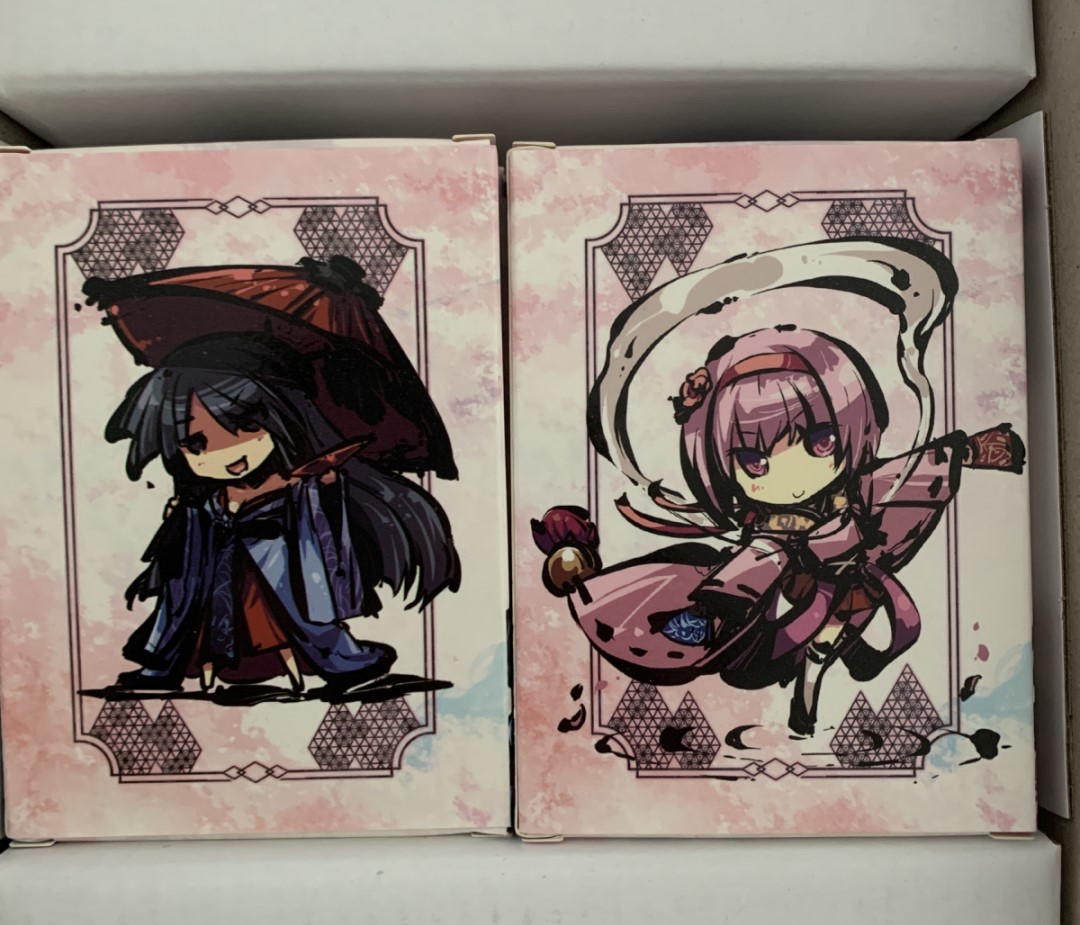 two card boxes featuring chibi artwork of girls on them