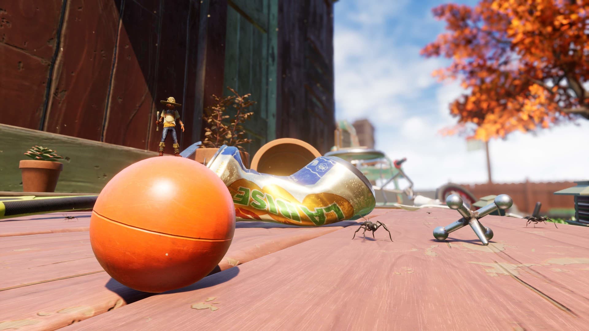 Screenshot of grounded from Steam, with a player standing on top of a ball near some jacks, and ants on the picnic table 