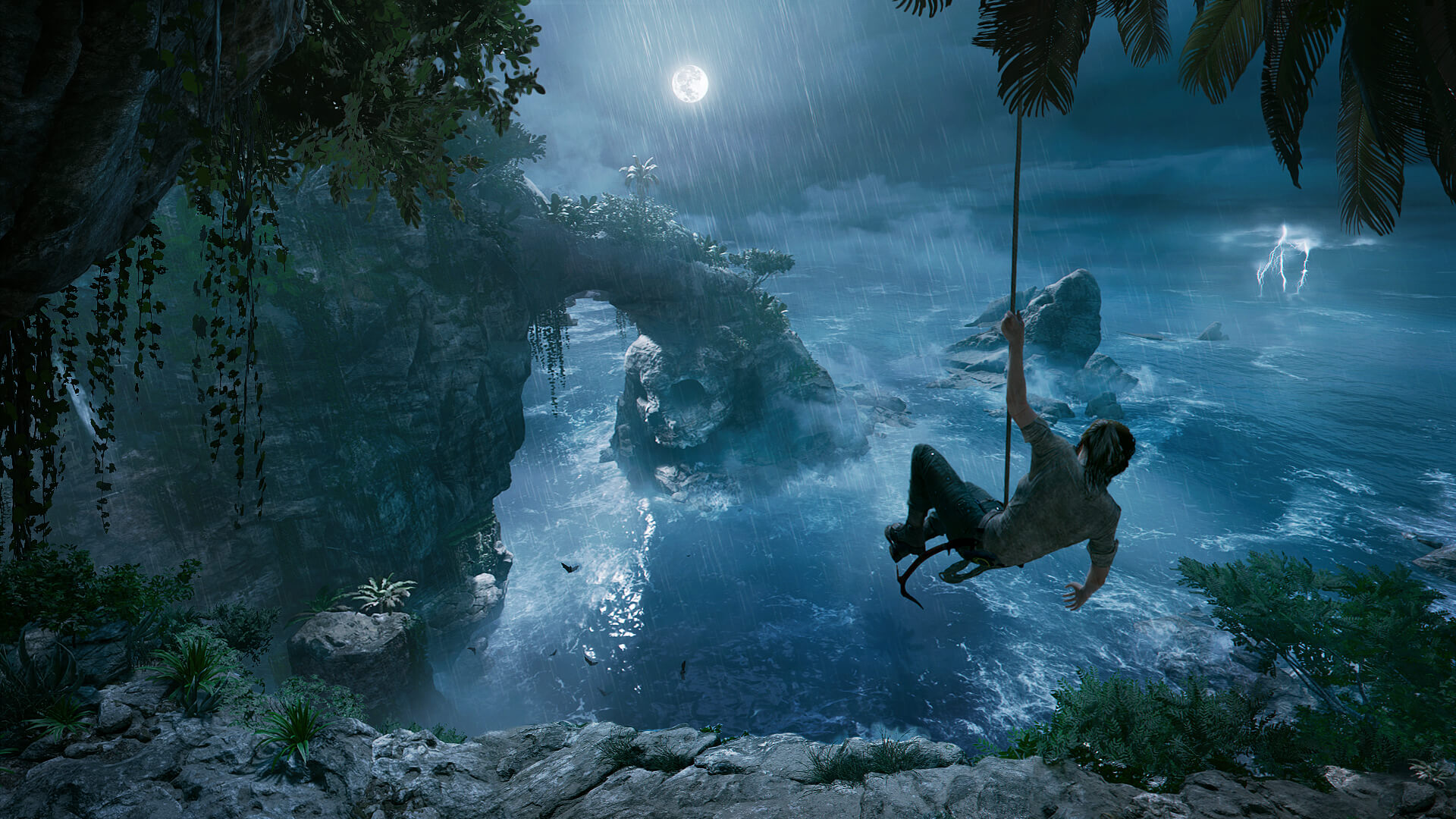 Lara swinging from a rope in Shadow of the Tomb Raider
