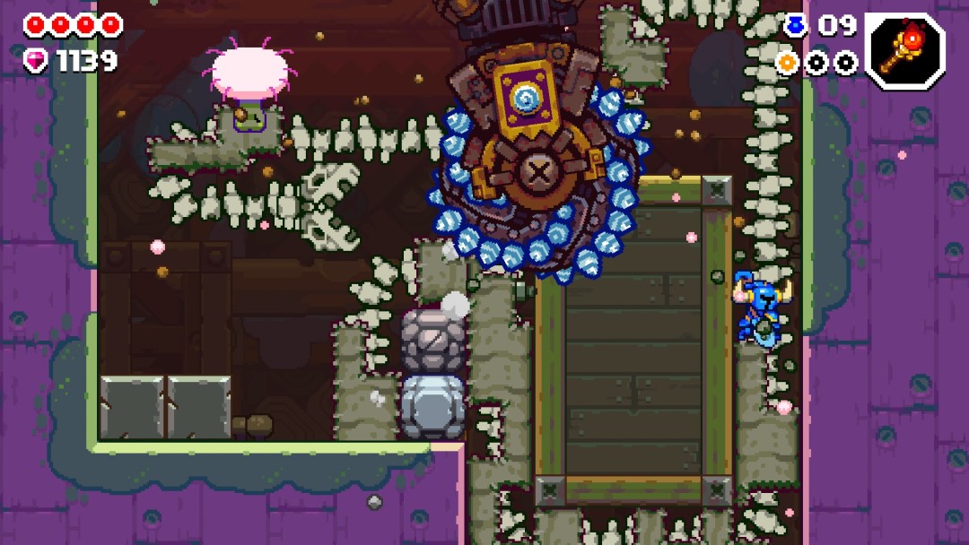 A screenshot from Shovel Knight Dig with a giant drill bearing down on Shovel Knight