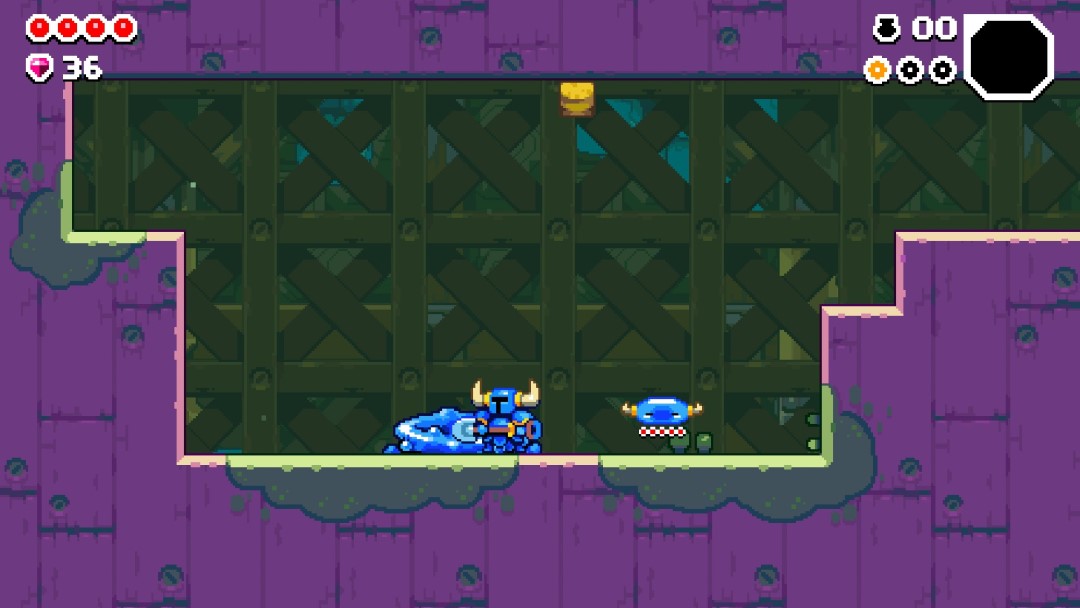 A screenshot from Shovel Knight Dig showing Shovel Knight and a blue slime