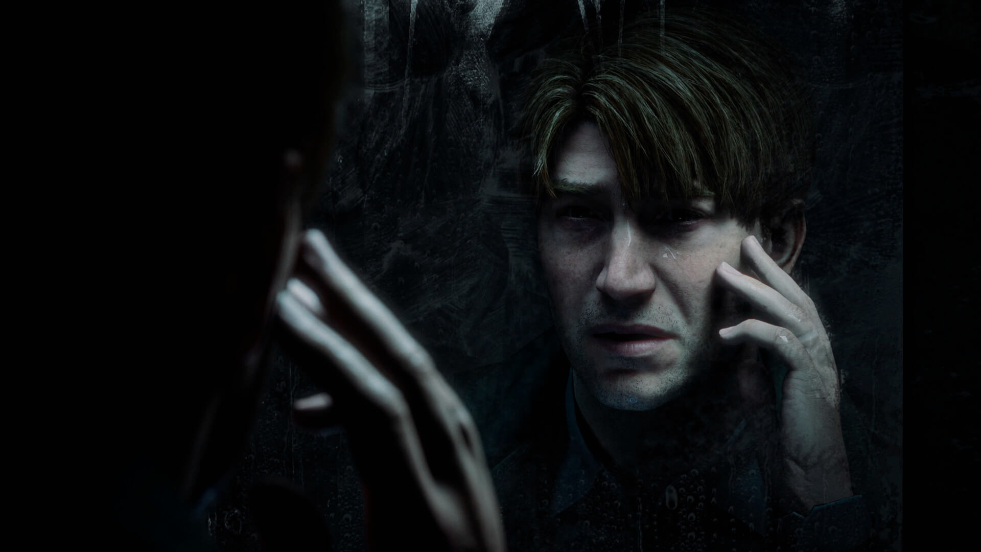 James Sunderland touching his face in the mirror in the Silent Hill 2 remake
