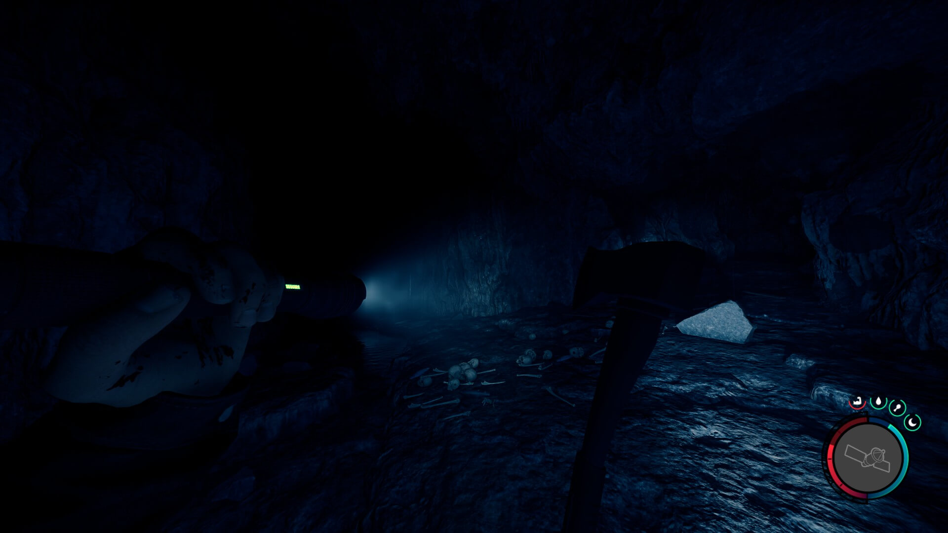 Sons of the Forest screenshot showing a cave with two paths, with the player holding a flashlight.