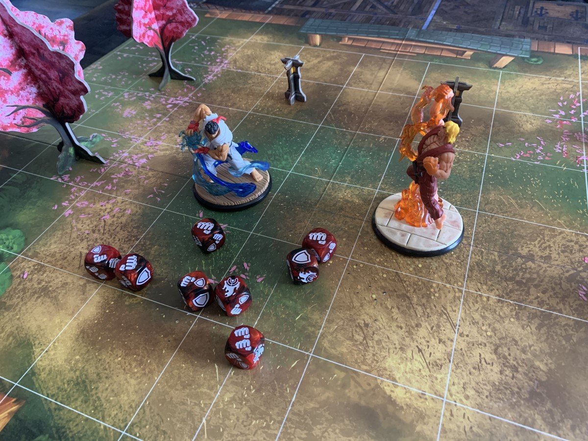 Ryu and Ken in the garden map, combat dice laid out