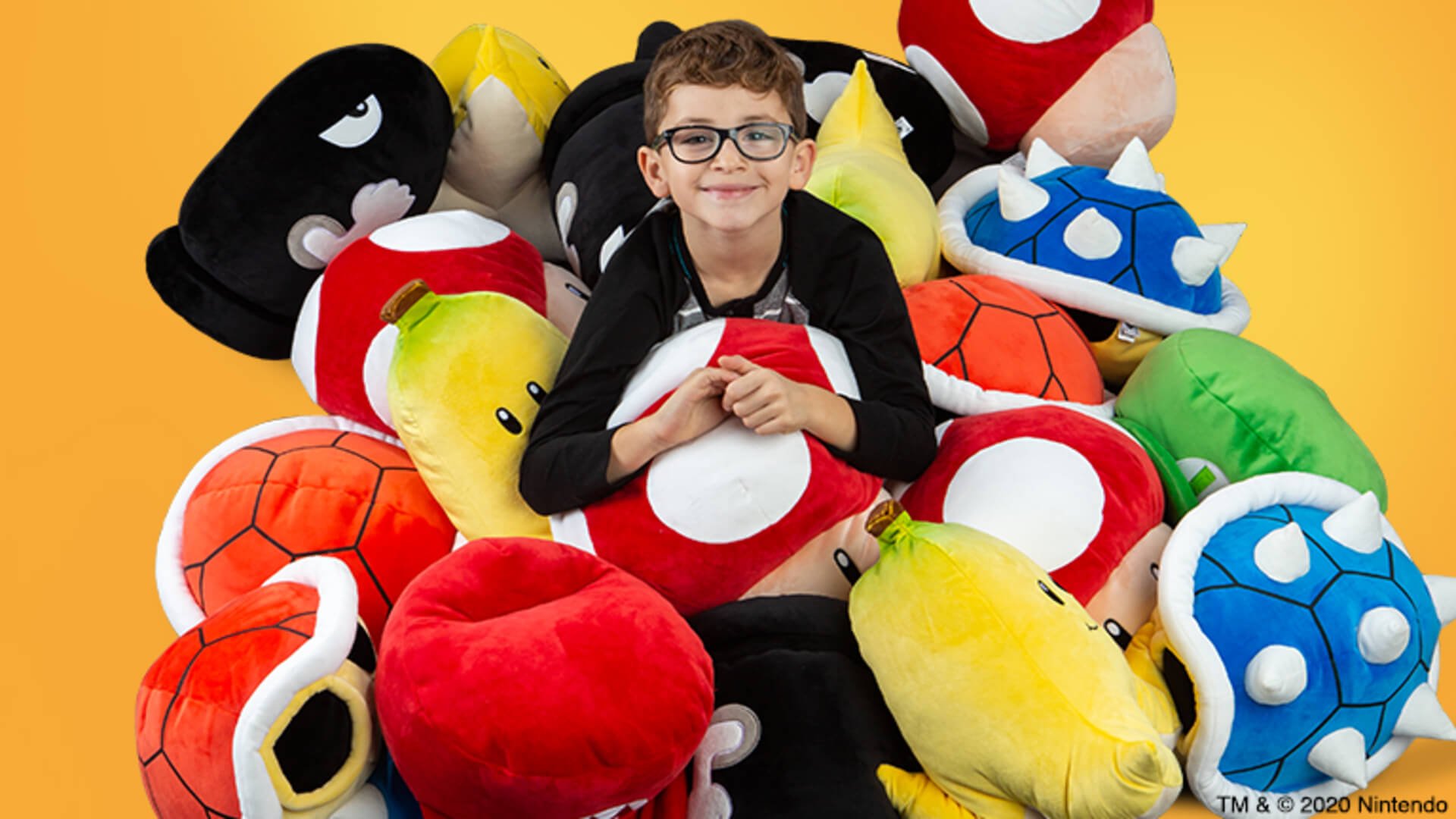 A boy with some Super Mario-themed Club Mocchi Mocchi plushies from TOMY.