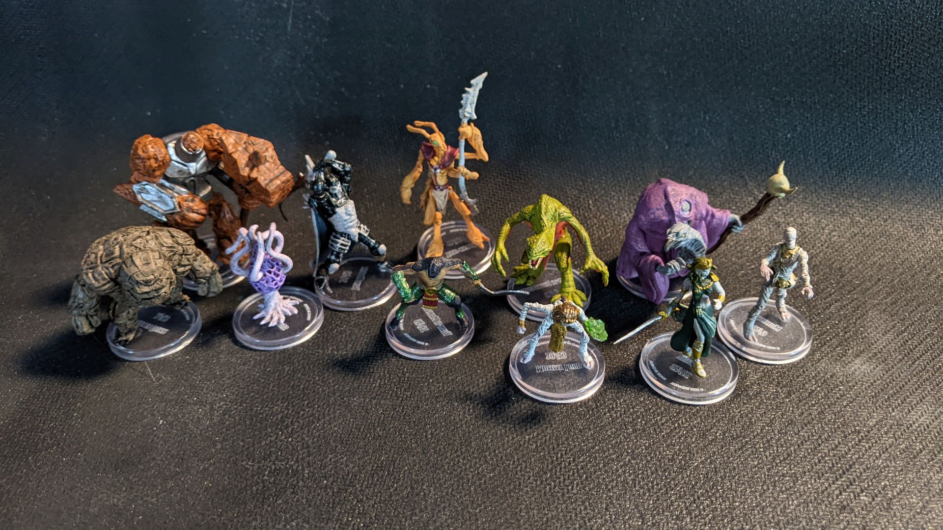A group of humanoid minis from Wizkids Sand and Stone Blind Box Set