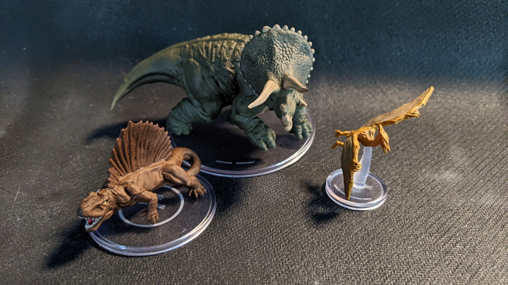 A group of dinosaurs from Wizkids Sand and Stone Blind Box