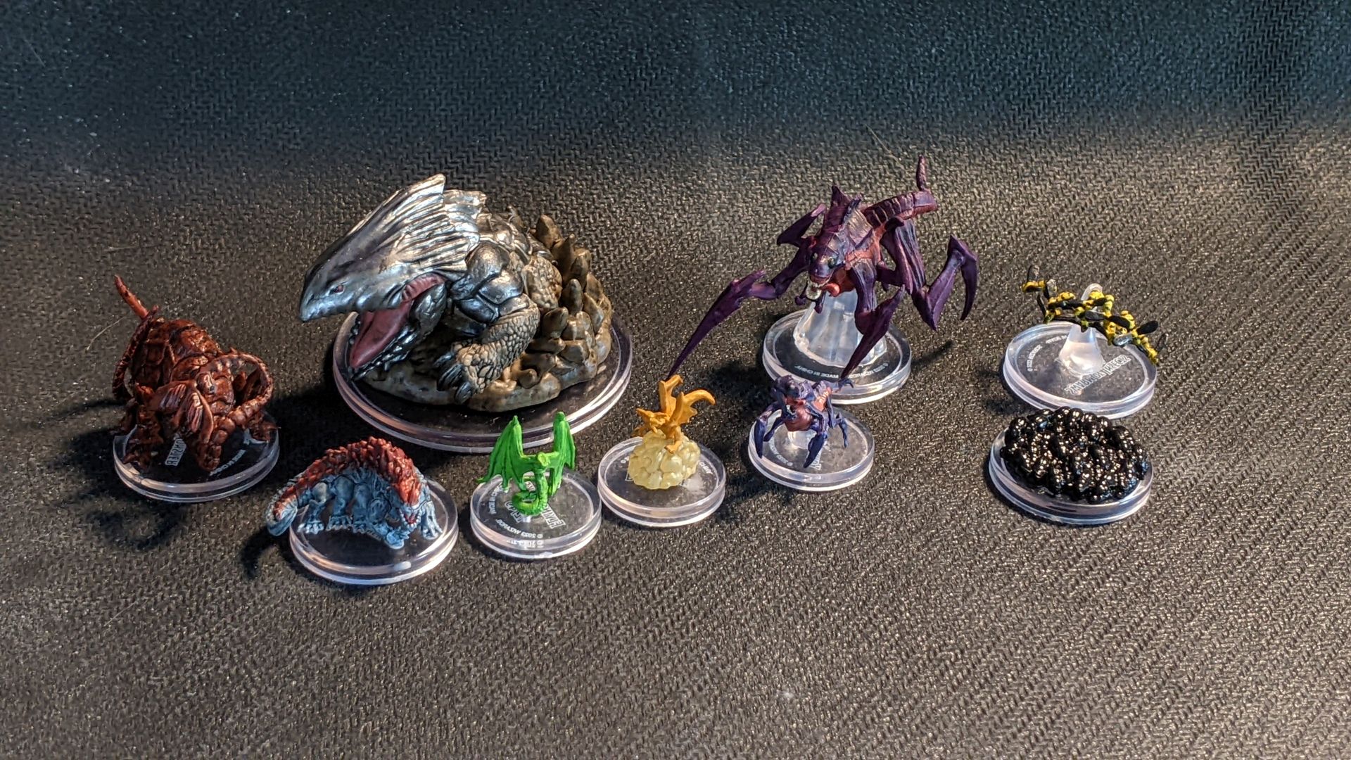 A group of monsters and were creatures from Wizkids Sand and Stone Blind Box