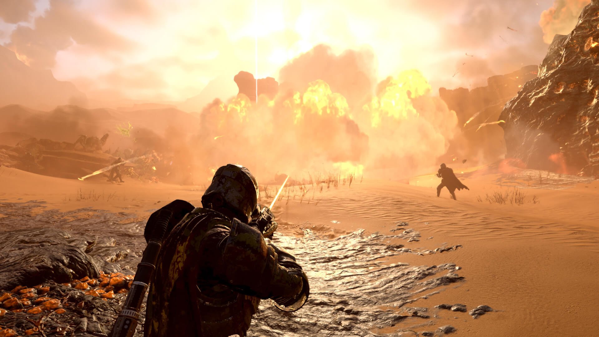 Helldivers 2 で遠くで爆発が起こる中、プレイヤーが虫の大群に向けて発砲する