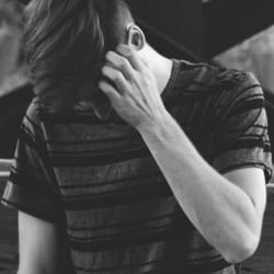A black and white image of Austin fixing his hair