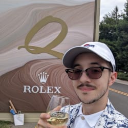 Image of Gabriel Ionica In Front of a Rolex Sign