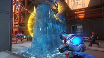 Overwatch screenshot showing a giant wall of ice that has sprung up between two different groups of fighting characters