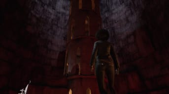 Emem staring at a tall stone tower in a large cavern