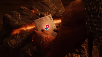 A demon holding a book with the Domino's Pizza logo on it, intended to represent the Oblivion mod that lets you buy Domino's Pizza