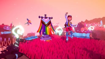 A Temtem player jumping for joy next to a Pride-themed flag banner