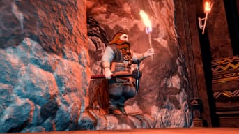 A dwarf clutching a pickaxe and emerging from a rock tunnel in The Lord of the Rings: Return to Moria