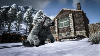 A creature in Ark: Survival Evolved sitting outside a snow-capped house
